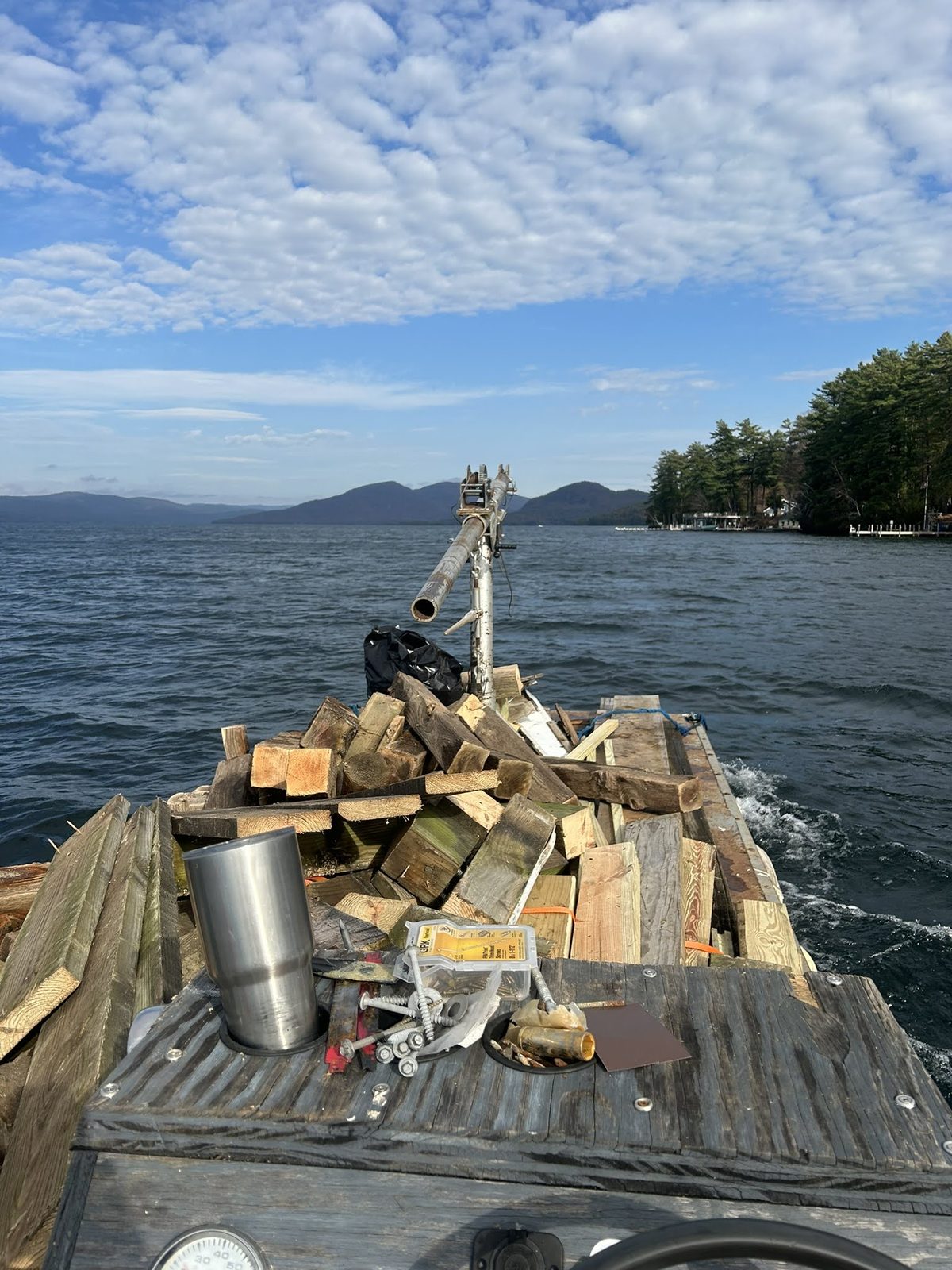 Work barge carrying timber and materials across Lake George