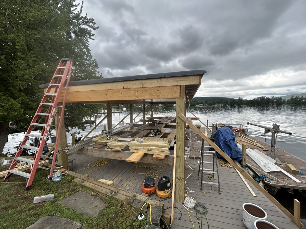Boathouse reconstruction with staging over the water