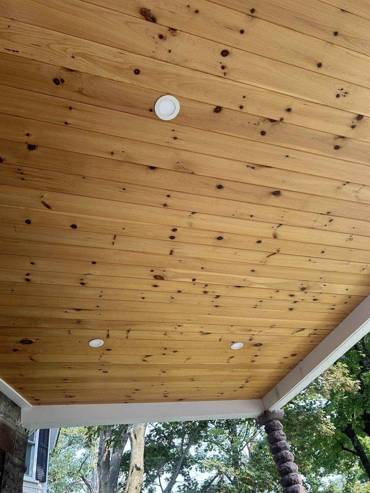 Tongue-and-groove pine ceiling with recessed lighting in a covered dock