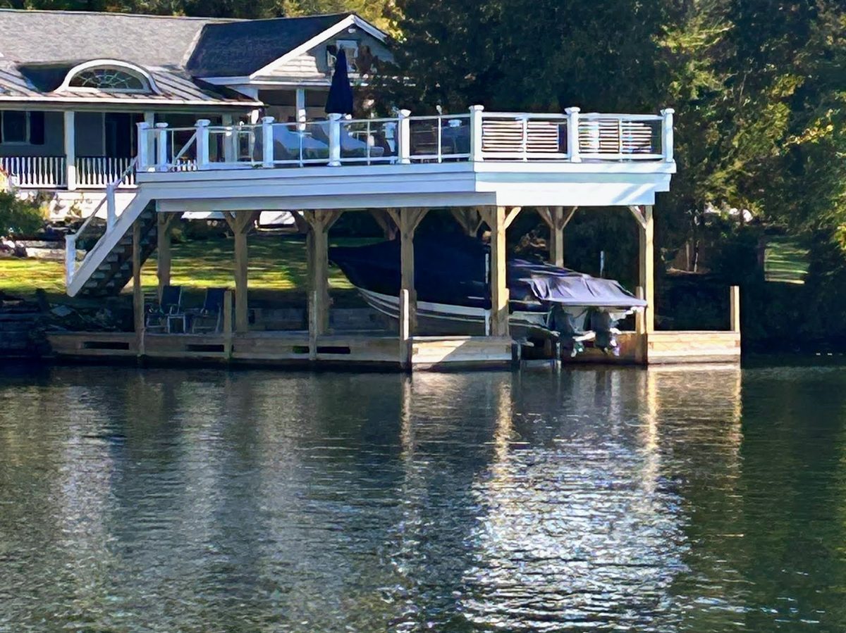 Two-story boathouse with upper sundeck and covered boat slips