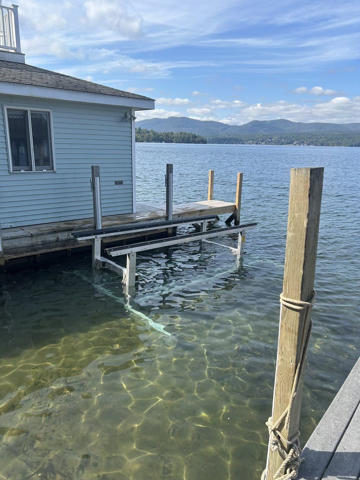 Boat lift cradle visible through clear Lake George water