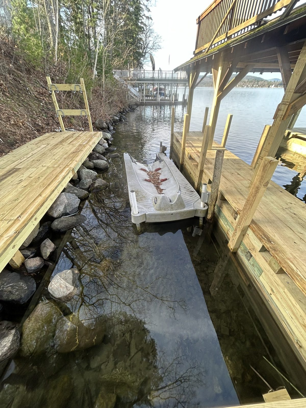 Boat lift positioned along a rebuilt rock shoreline