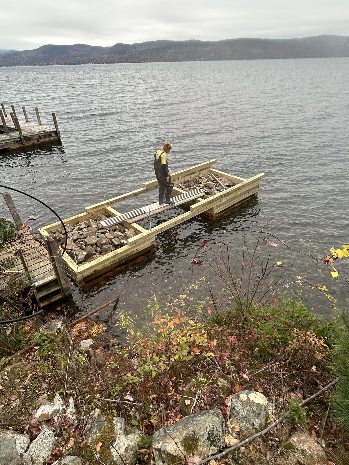 Newly built timber crib set into position along the shore