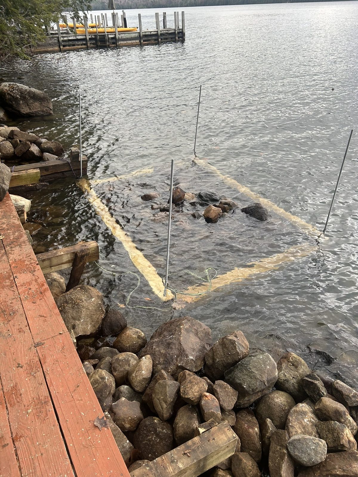 Submerged crib and stone base visible through clear water