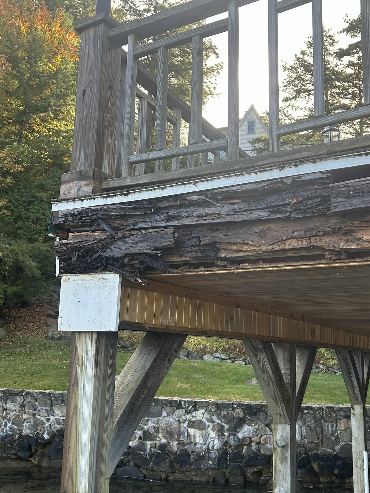 Rotted deck beam and post showing structural failure