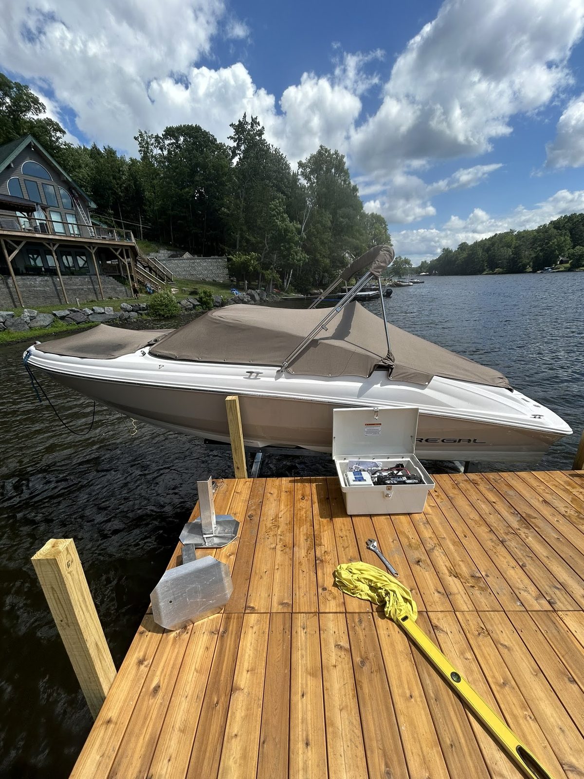 New wood dock with boat pulled alongside on a summer day