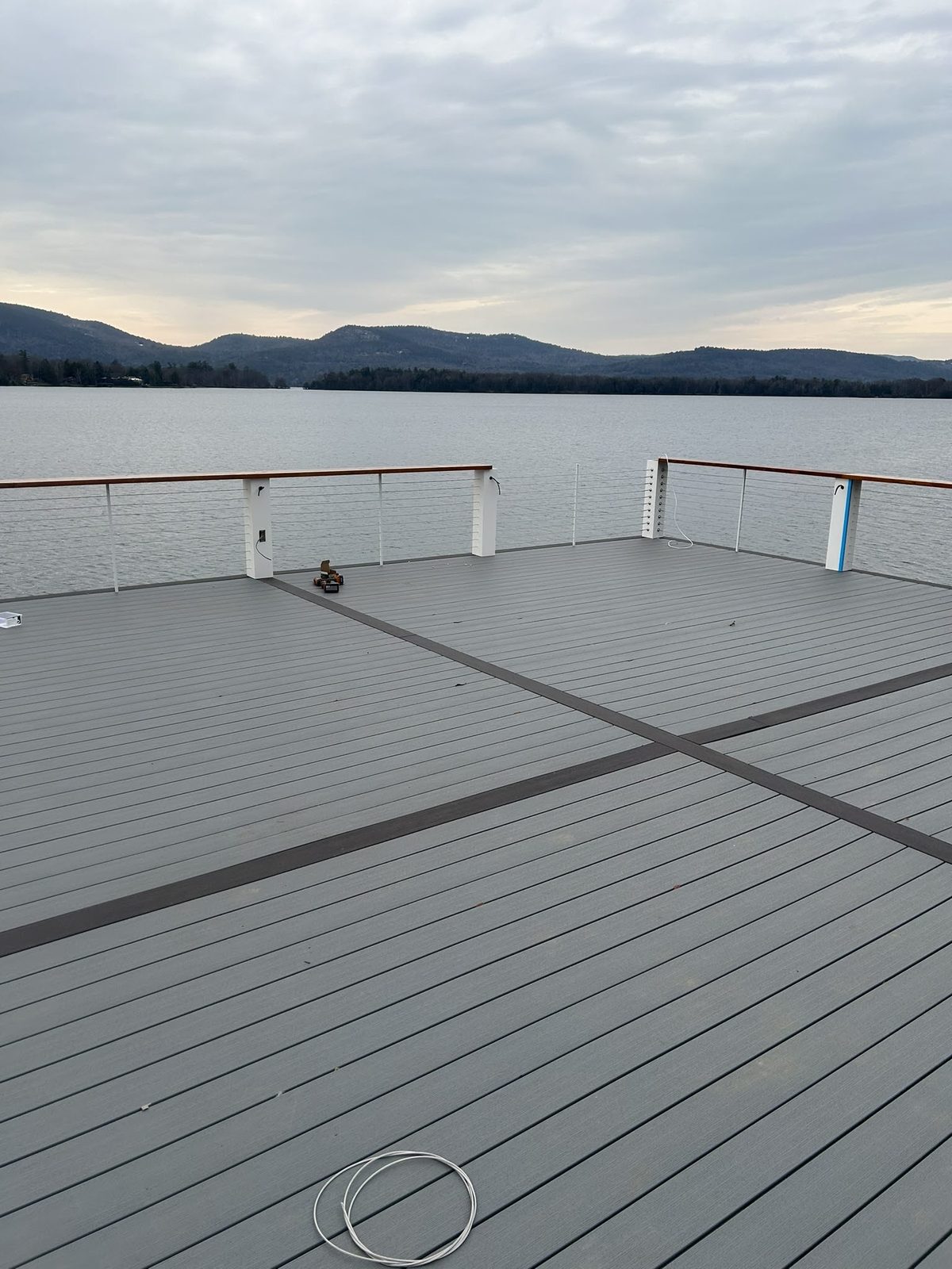 Dock platform with cable railing at dusk on Lake George
