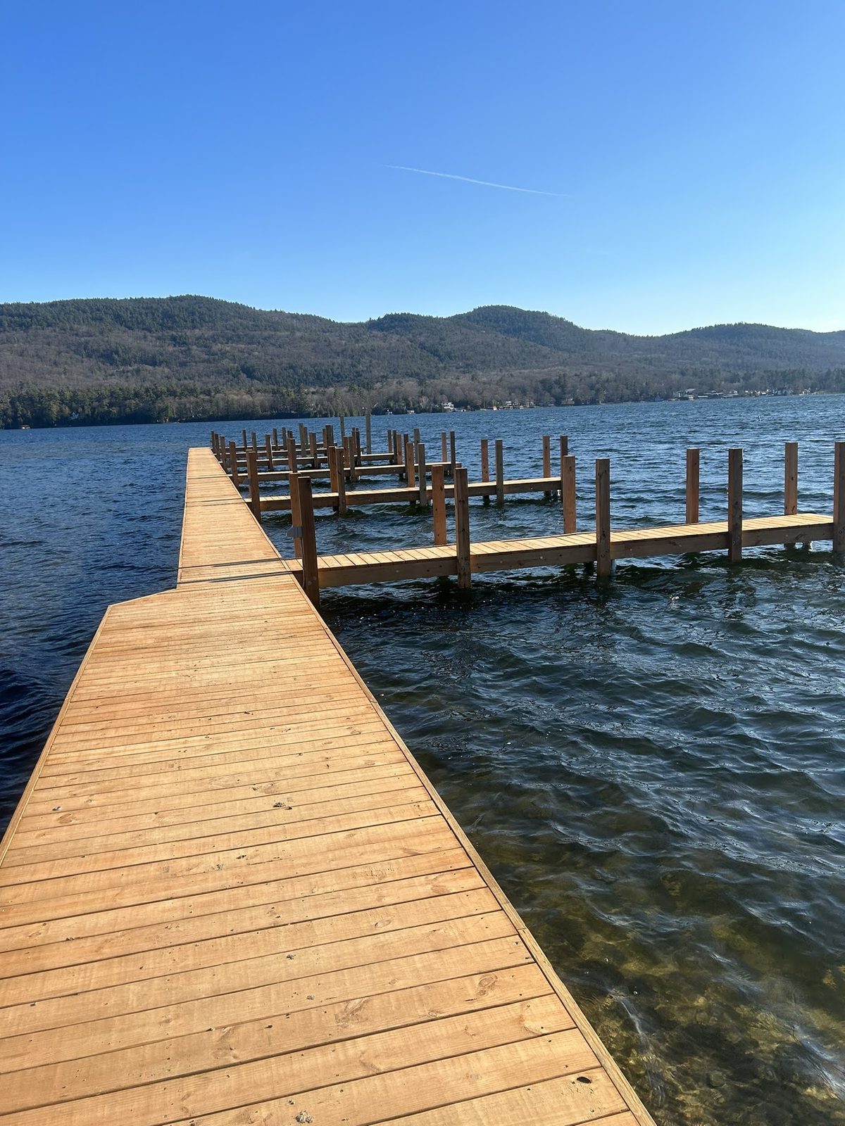 Classic Lake George crib dock with wood decking and open water beyond