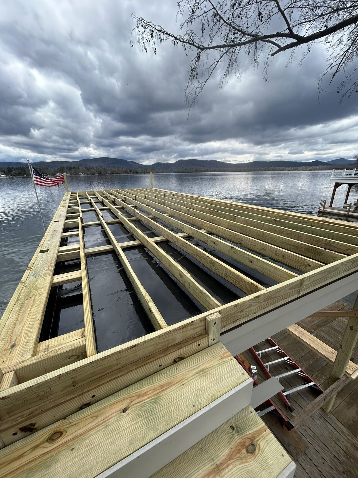 Dock framing and joists set over Lake George before decking