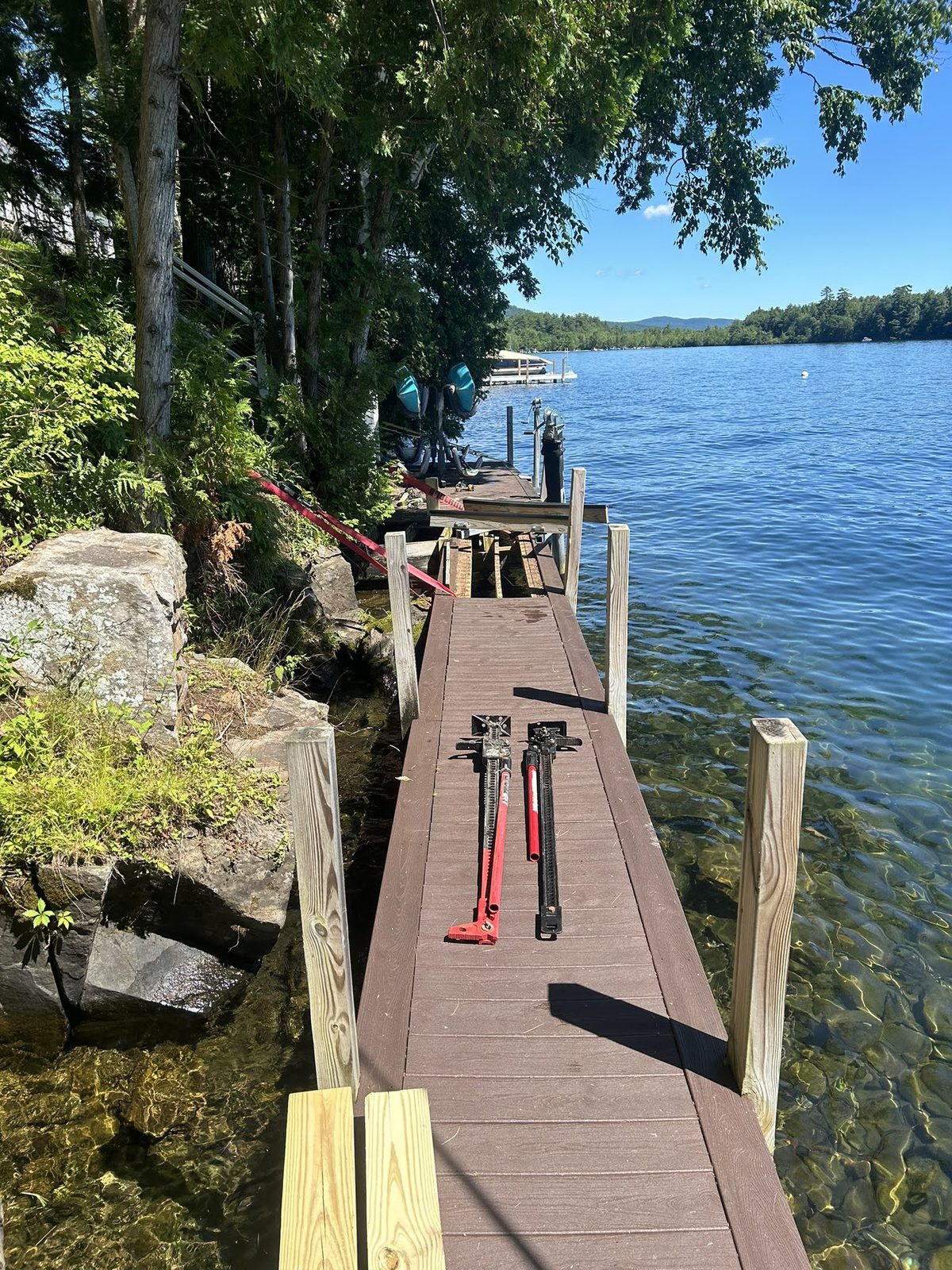 Dock and shoreline walkway among boulders and pines