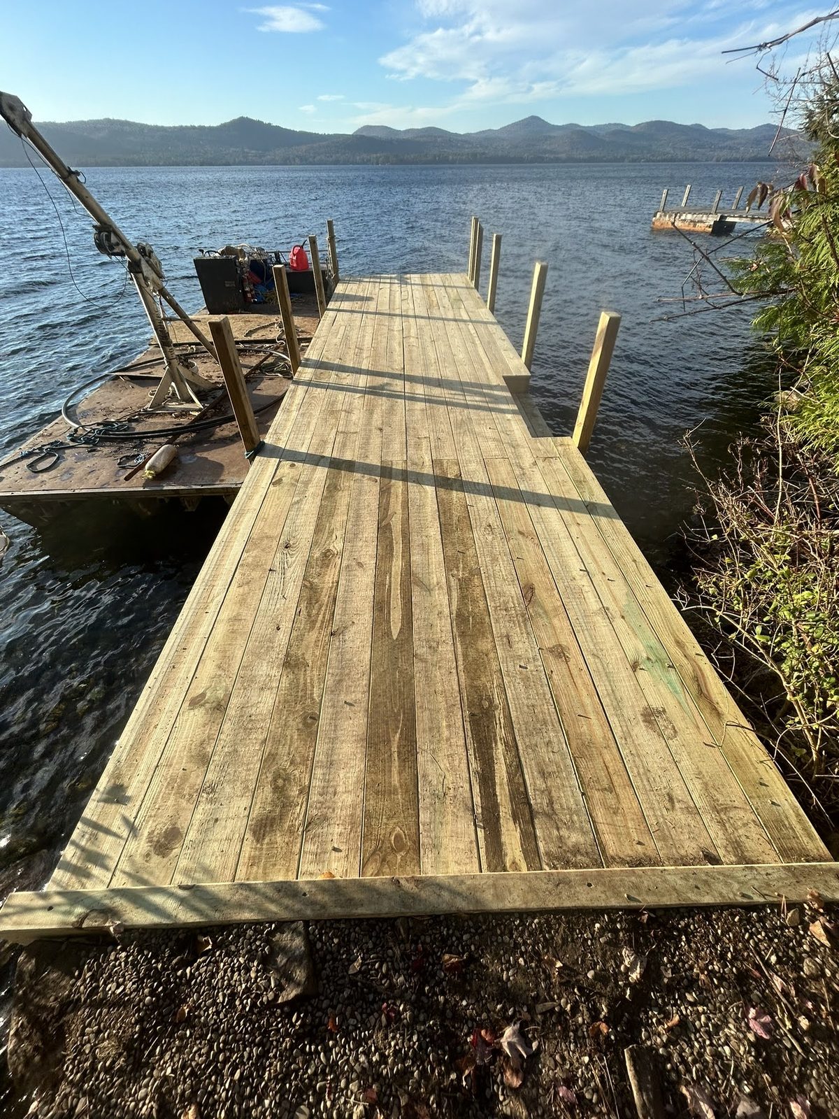 Long timber dock walkway reaching out to deeper water