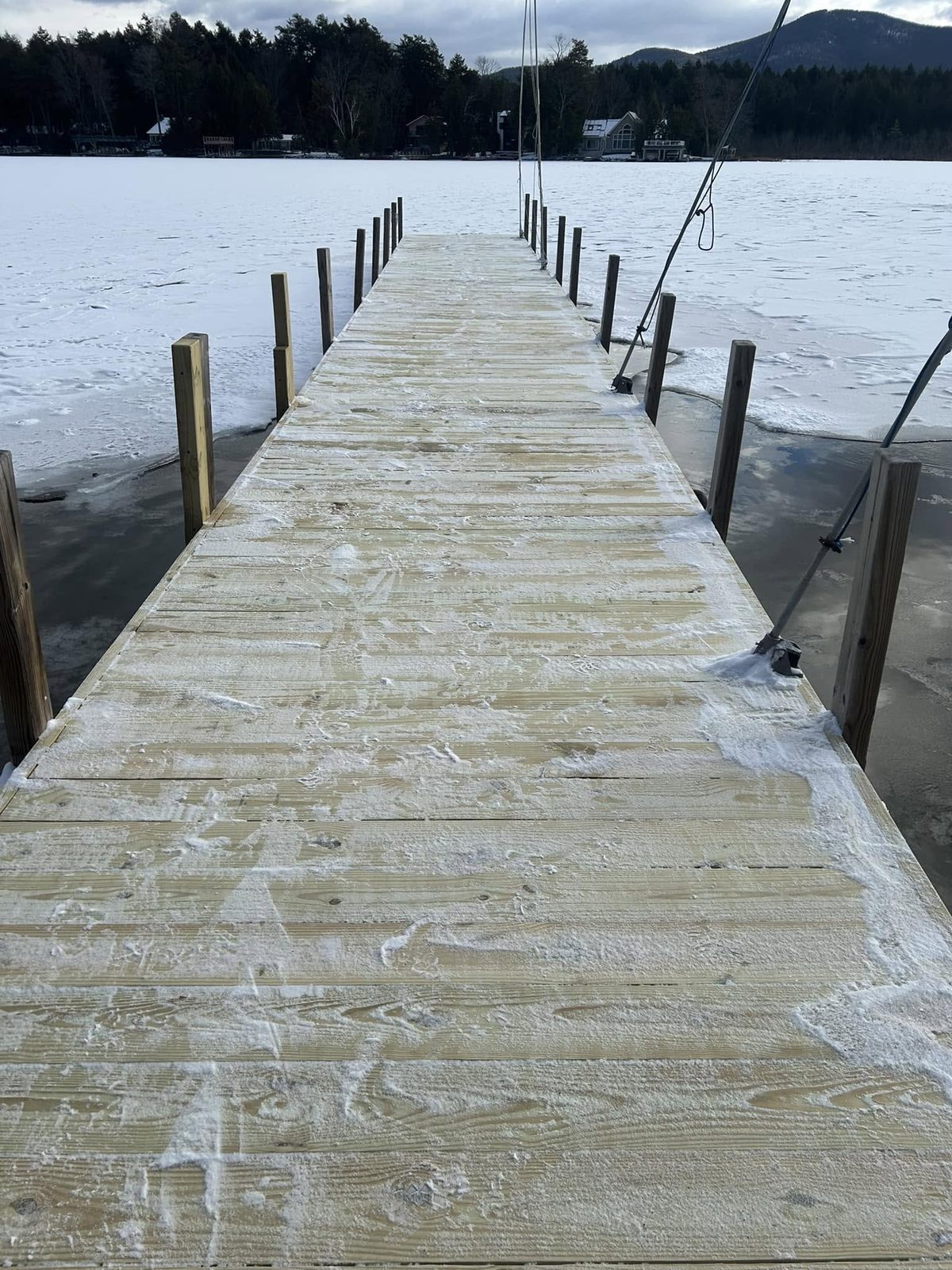Resurfaced dock with new pressure-treated decking and a picture-frame border, ready for winter