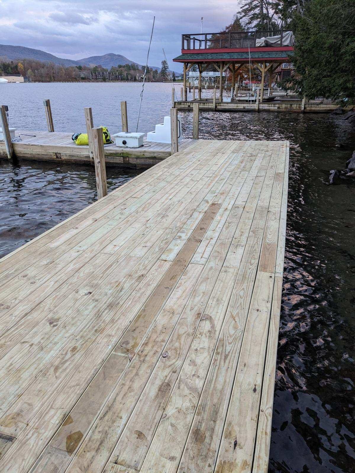 New dock decking meeting a rocky Lake George shoreline