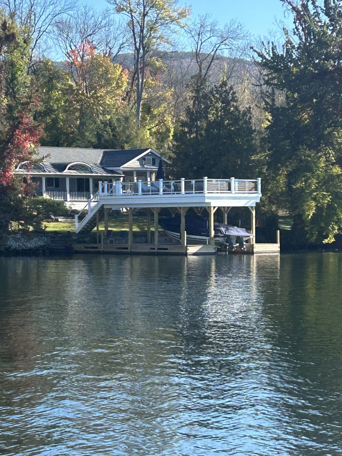 Lake George waterfront estate with two-story boathouse and sundeck in fall
