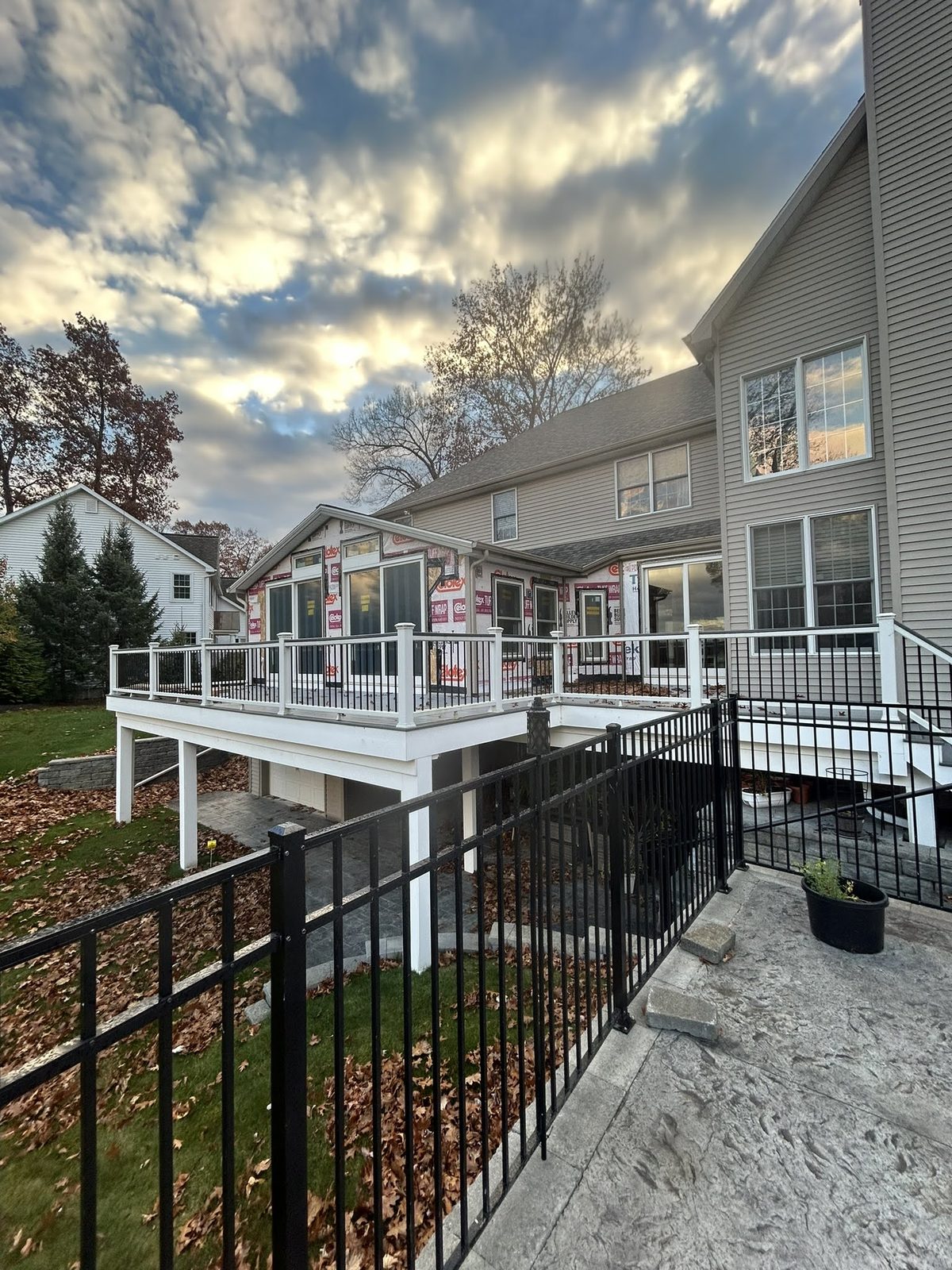 Finished home exterior with new deck and railing