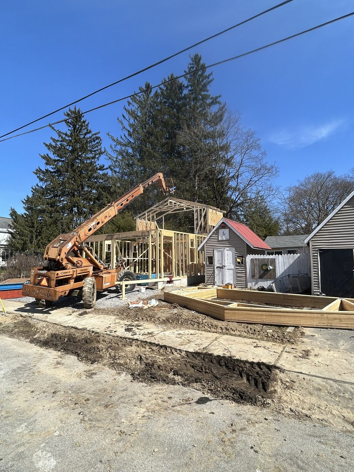 Lakeside construction with crane and staged materials