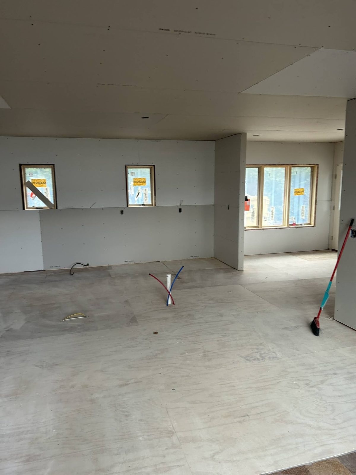 Open-plan interior framed and drywalled during a renovation