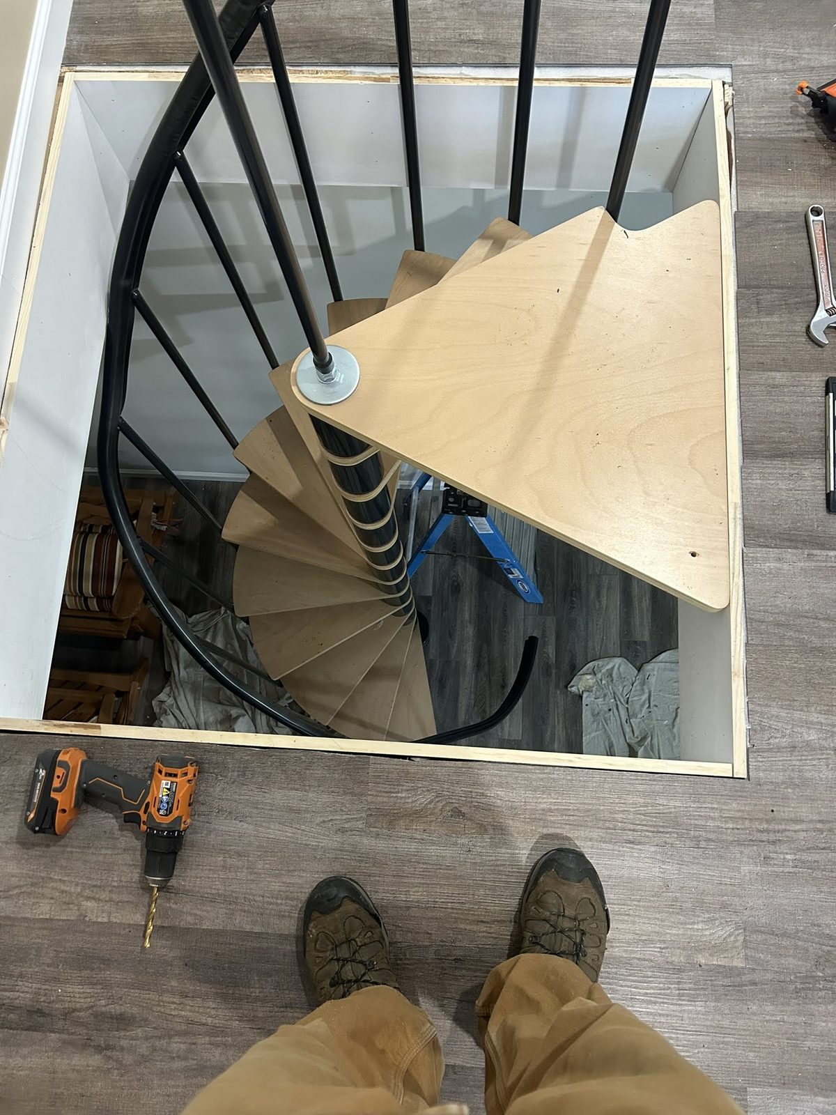 Spiral staircase installation viewed from the upper floor