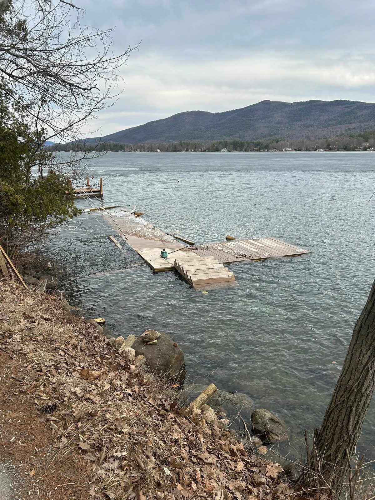 Winter ice damage to a Lake George dock before rescue and repair