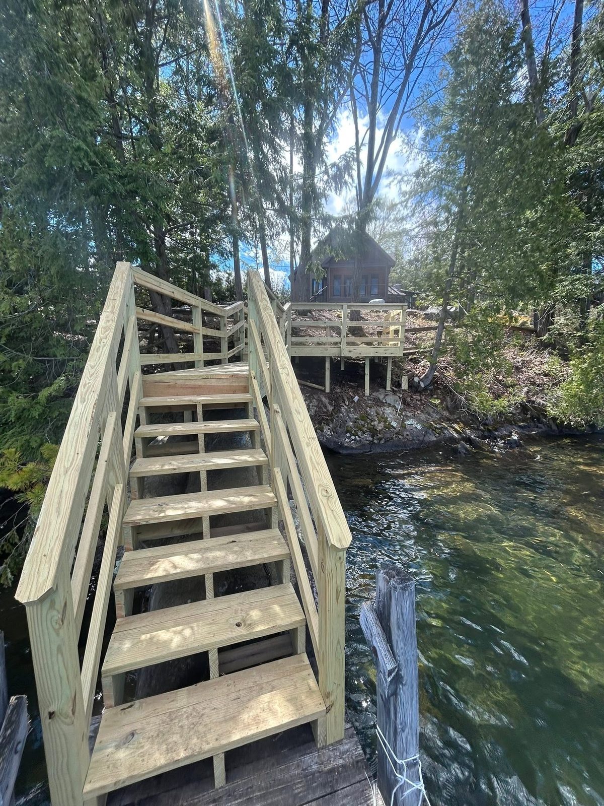 Finished stake dock and stair set at a Lake George property