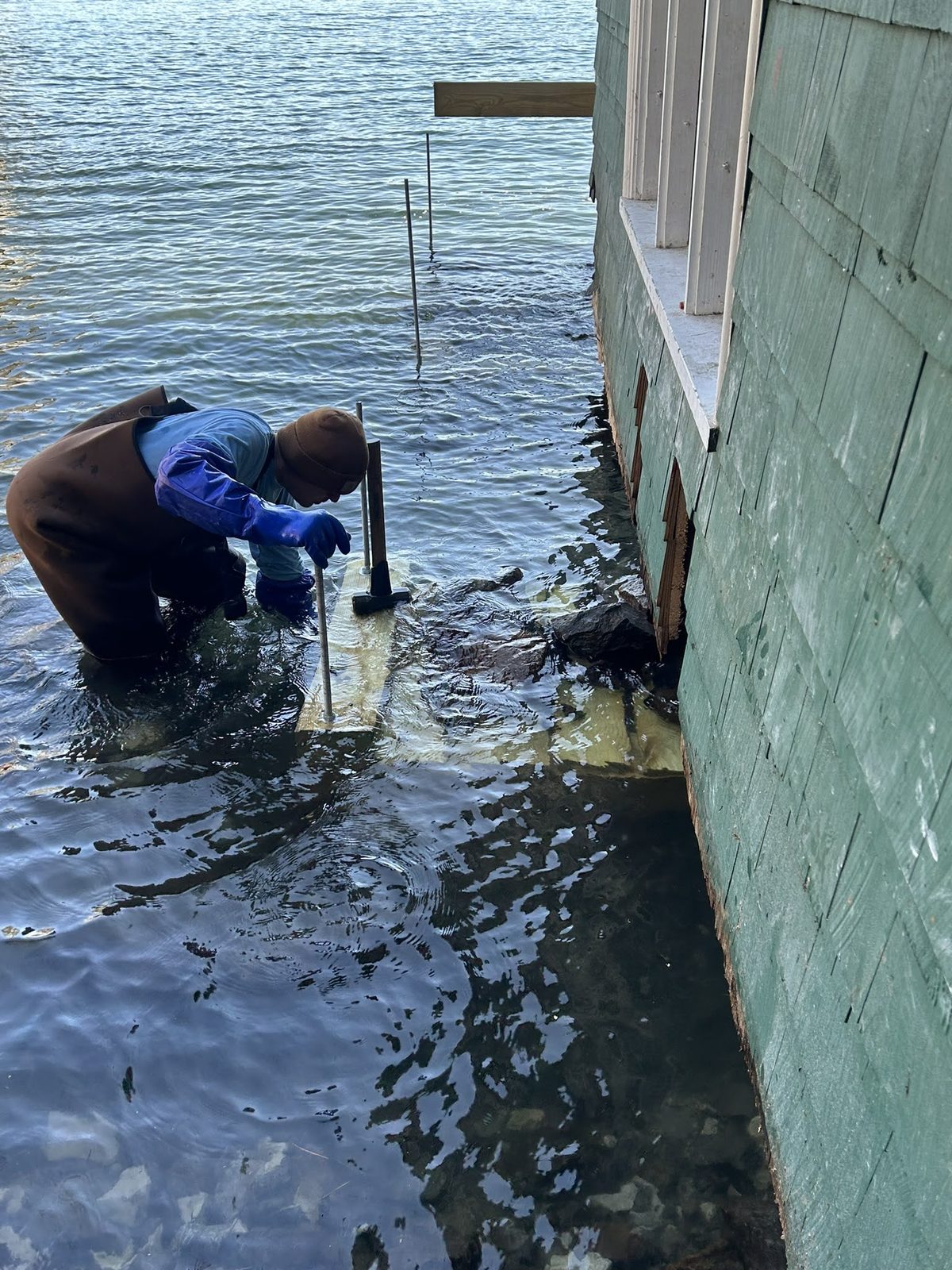 Technician working in the water on a submerged structural repair