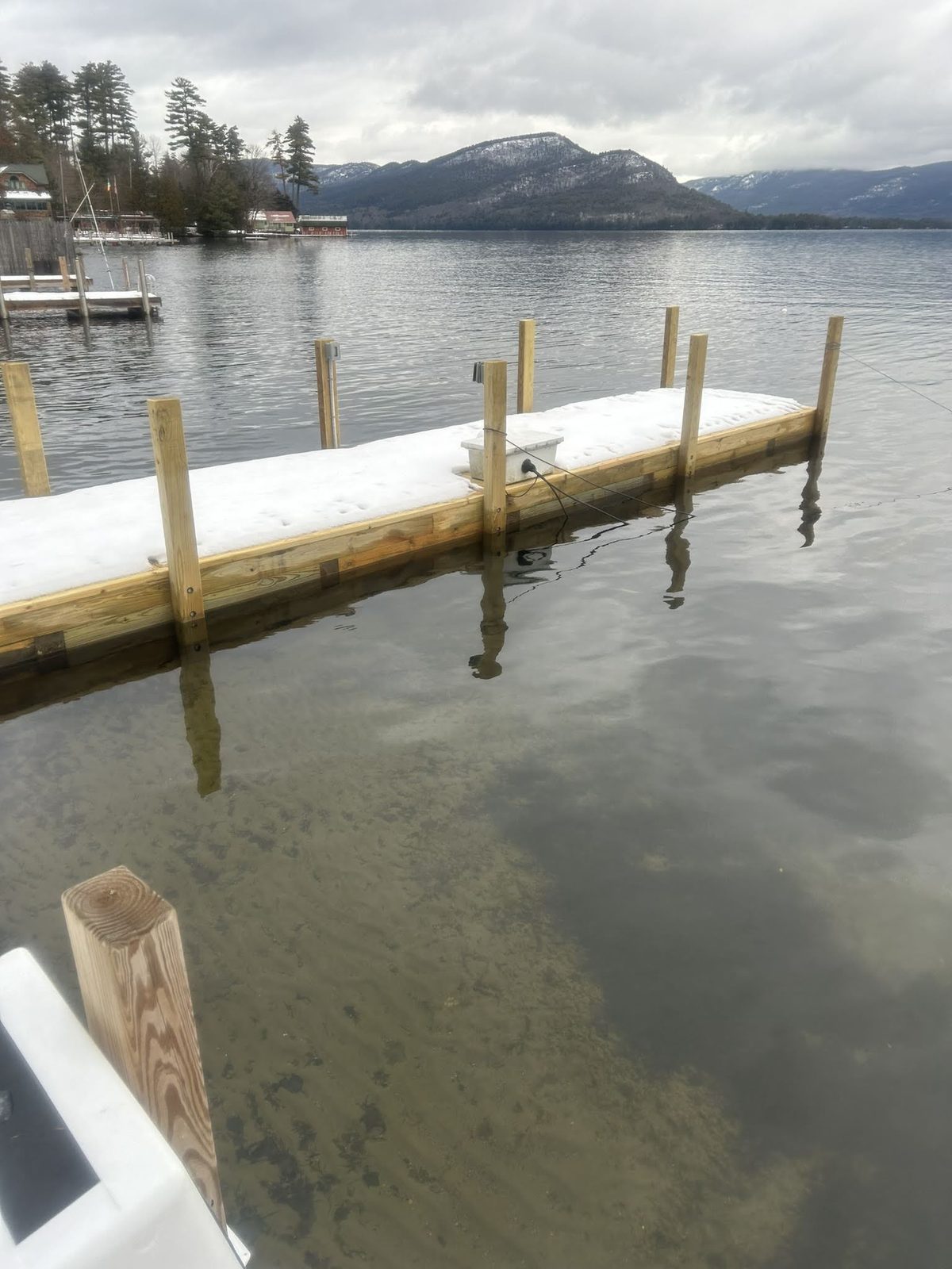 Winter dock with snow load and open water beyond