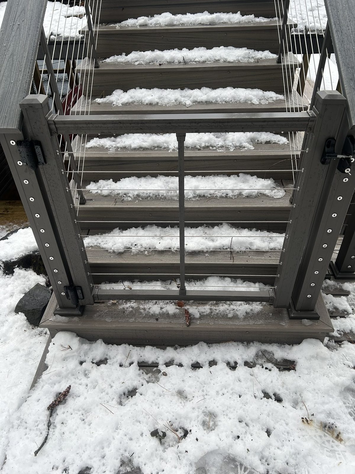 Snow-covered aluminum stairs on a Lake George waterfront property